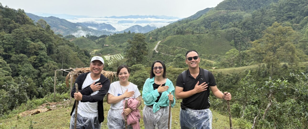 Lux Travel DMC product team surveying remote mountain trails and weather conditions during trekking in Northern Vietnam