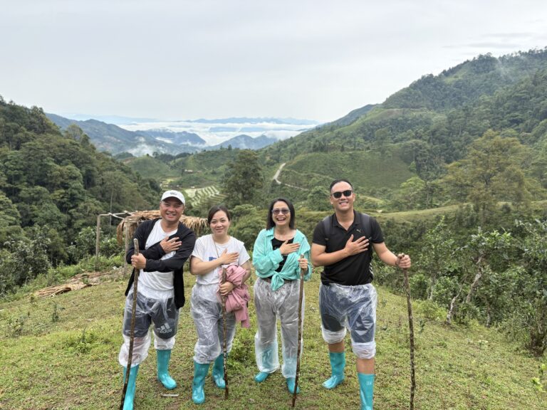 Lux Travel DMC product team surveying remote mountain trails and weather conditions during trekking in Northern Vietnam
